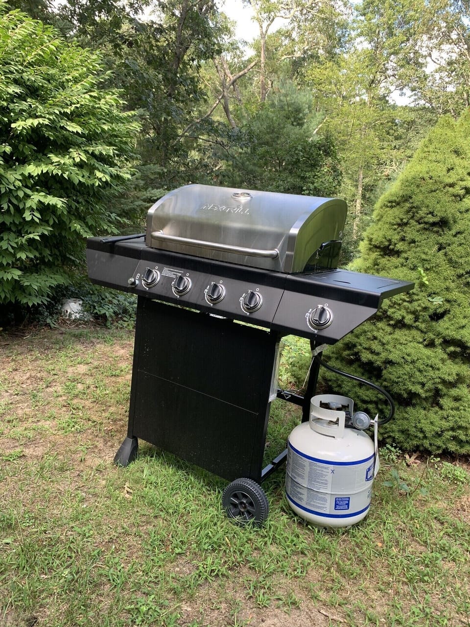 gas grill in outdoor seating area
