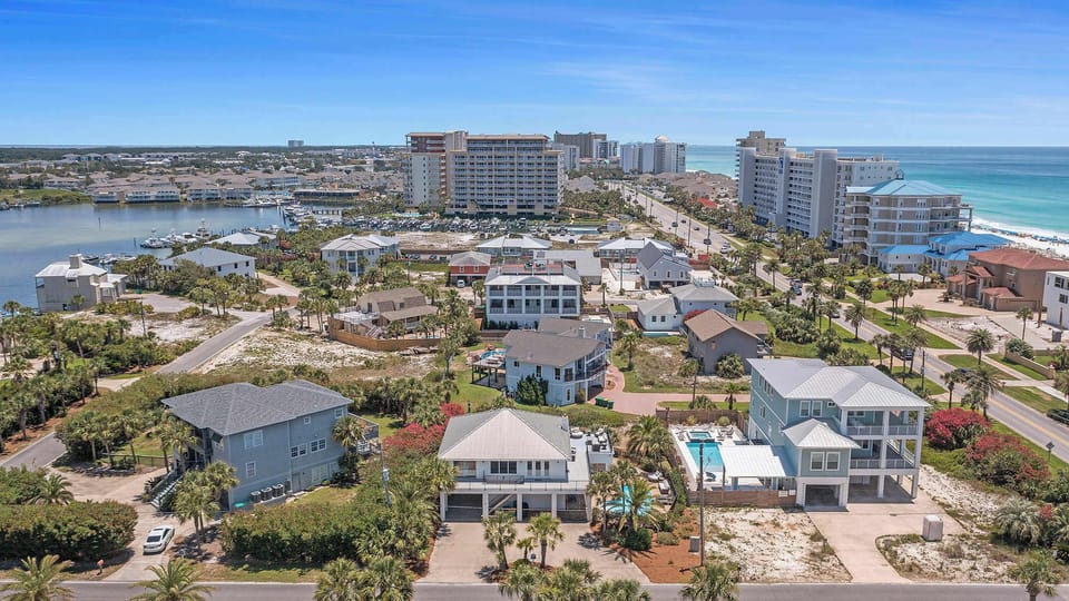 Wide aerial perspective highlighting the surrounding beachside neighborhood
