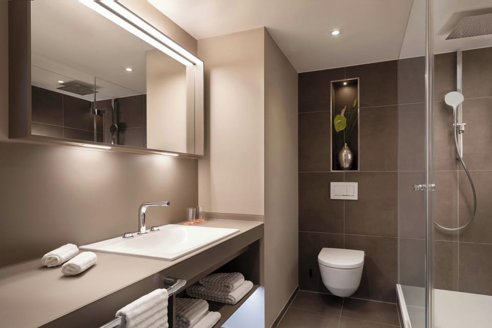 Shower, designer toiletries, hair dryer, bathrobes