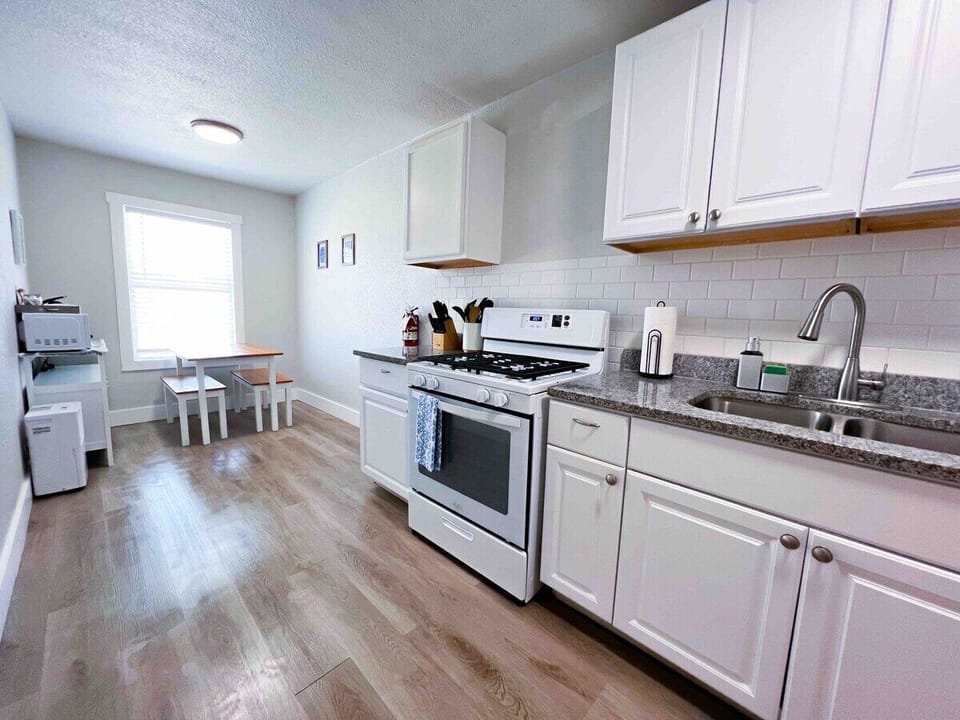 Discover a culinary paradise. Our kitchen is stocked with essentials like pots, pans, knives, cutting boards, and bakeware. Enjoy a gas stove, microwave, toaster, and a 12-cup coffee maker. Plus, enjoy complimentary coffee and sugar for a delicious morning.