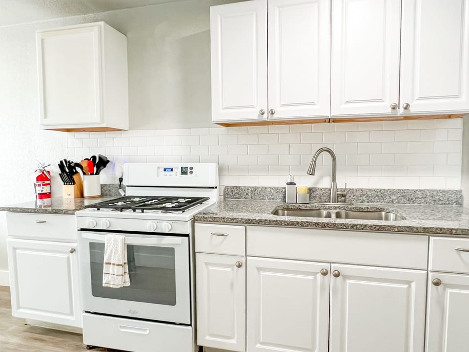 Discover a culinary paradise. Our kitchen is stocked with essentials like pots, pans, knives, cutting boards, and bakeware. Enjoy a gas stove, microwave, toaster, and a 12-cup coffee maker. Plus, enjoy complimentary coffee and sugar for a delicious morning.