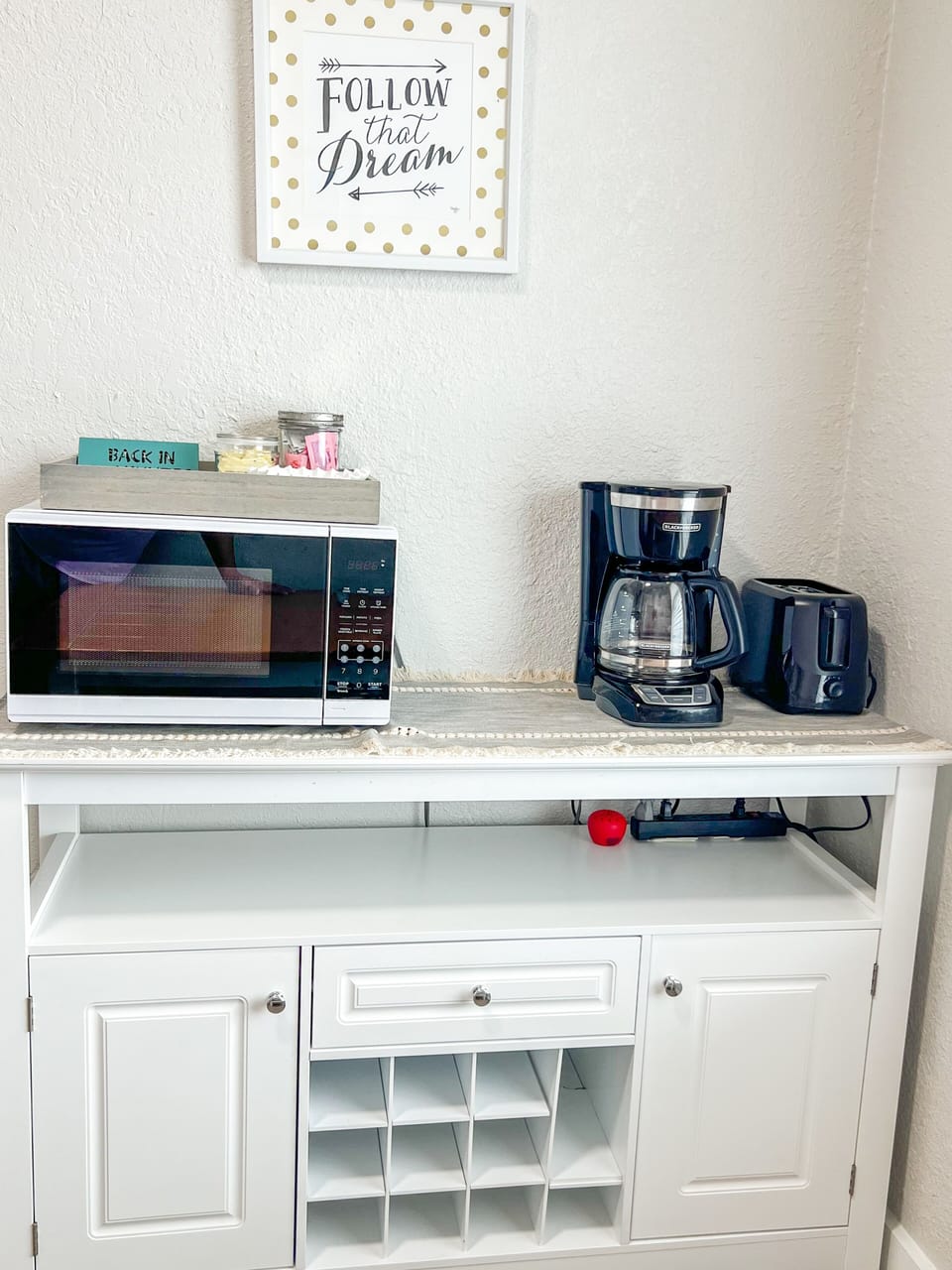 Discover a fully stocked kitchen with essentials like a microwave, coffee machine, and toaster.