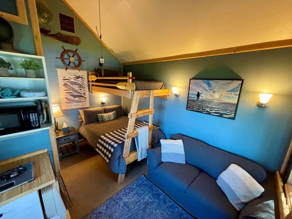 Open floor plan with full bed w/ twin bunk and pull-out bed loveseat couch