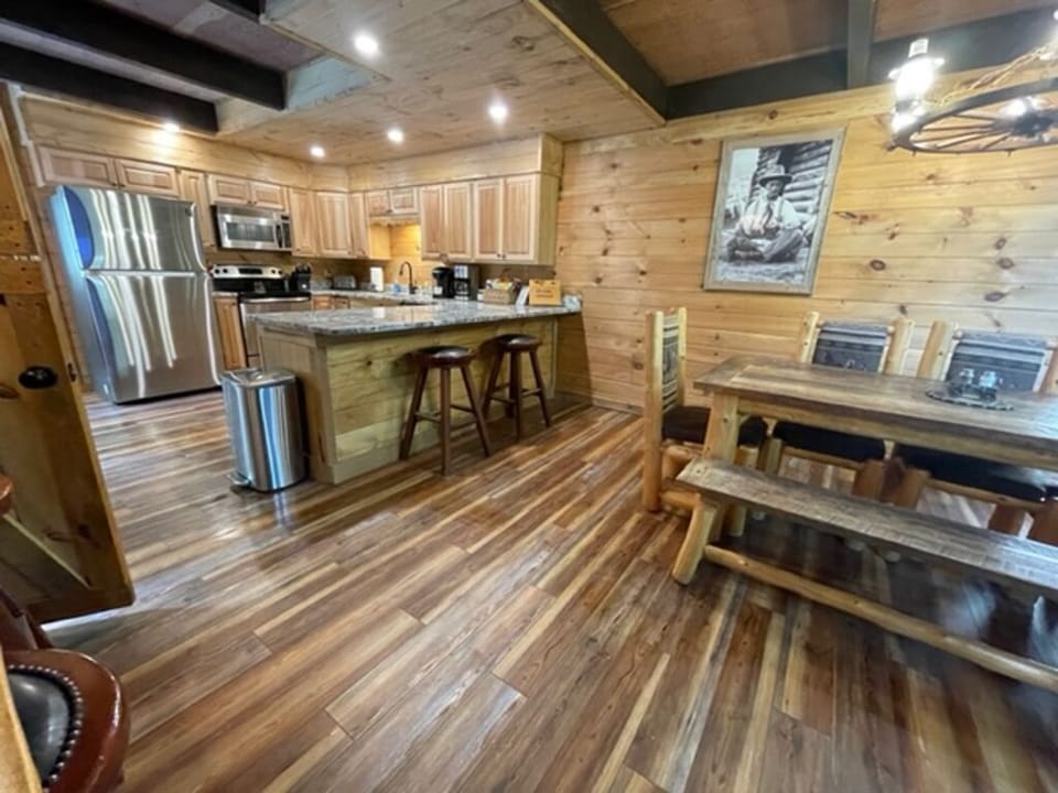 Main Level: Fully stocked kitchen with 2 breakfast bars & the log dining table.