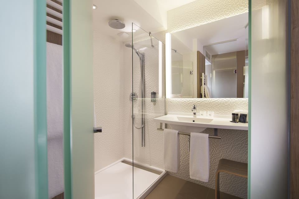 Shower, rainfall showerhead, hair dryer, towels