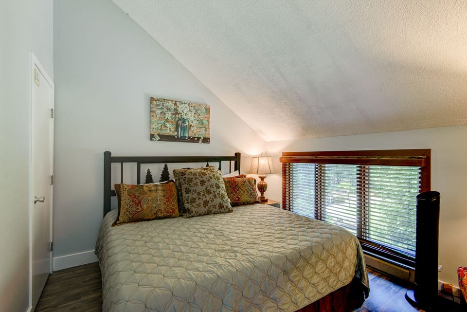 Curl up under a quilted comforter with treetop views peeking through the window at Top Of Seven.