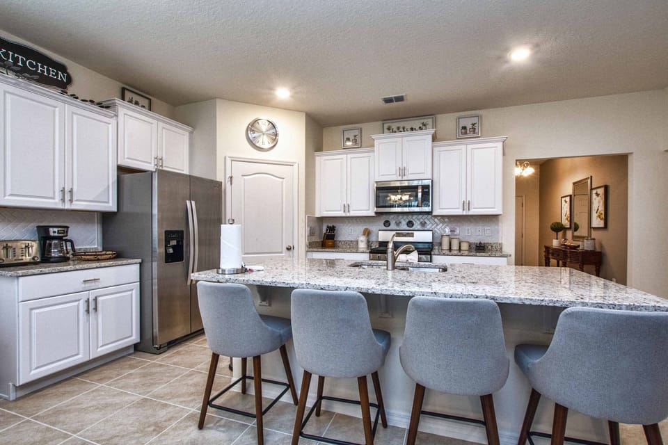 In the kitchen, we have stools for quick meals.