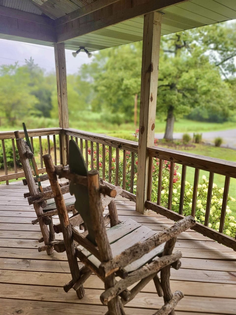Lots of outdoor space to enjoy the lush green setting from this 3/4 wraparound porch