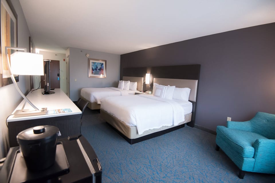 Room, 2 Queen Beds | Hypo-allergenic bedding, in-room safe, desk, blackout drapes