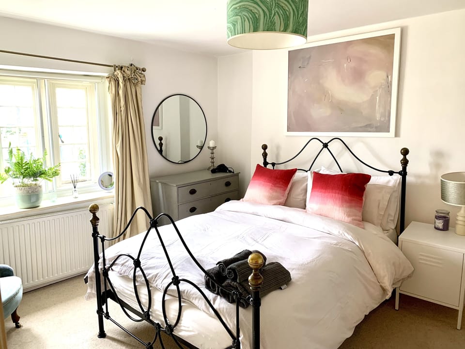Master bedroom with cotton bedlinen and feather bedding.