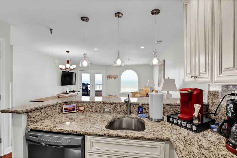 Open concept with kitchen overlooking the ocean and living room.