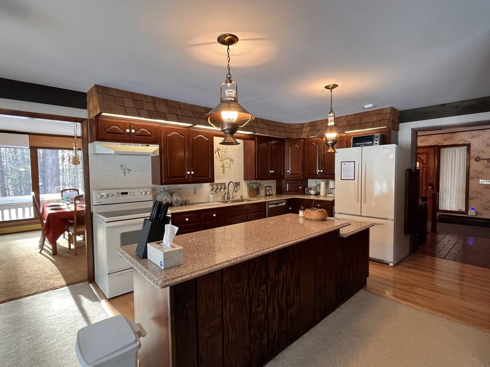 Kitchen with view to entry (right) and formal dining room (left).