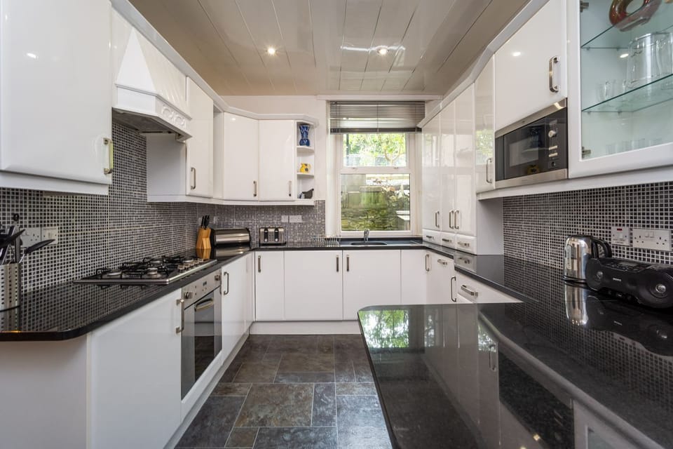 The modern kitchen is equipped with dishwasher, fridge/freezer, electric hob, oven, microwave and washing machine