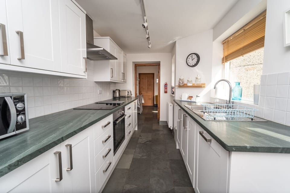 The kitchen is equipped with oven, hob, dishwasher and microwave