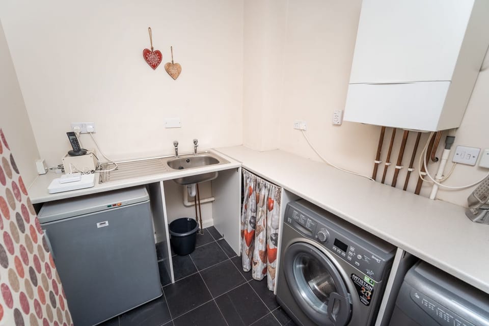 The well equipped utility area with room to store coats and boots