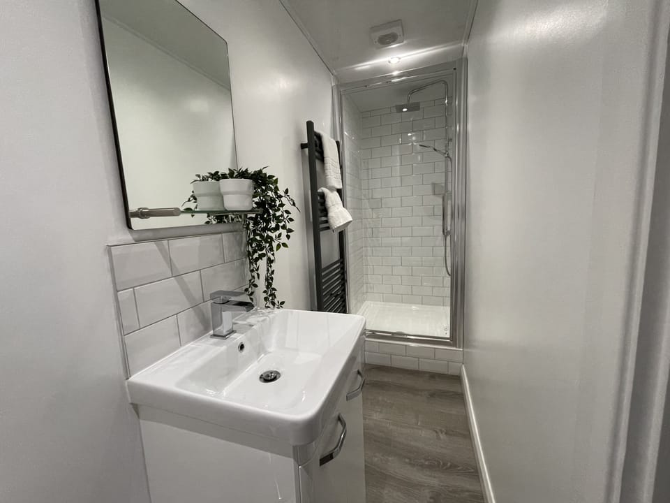 The shower room has a similar style to the family bathroom