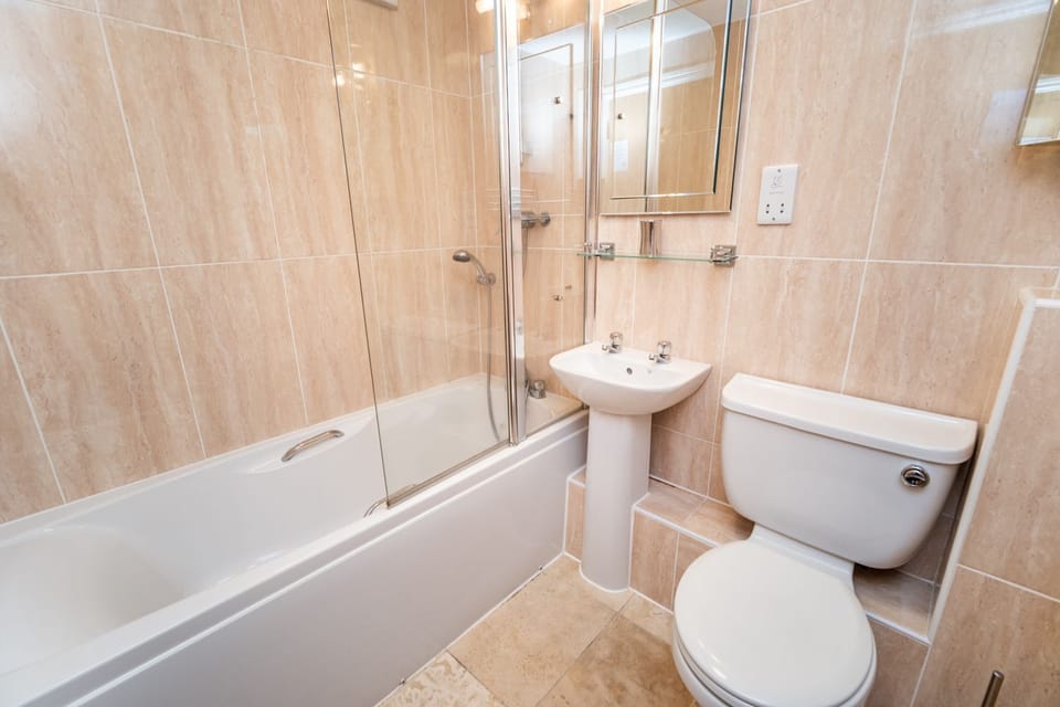 The family bathroom with bath and overhead shower
