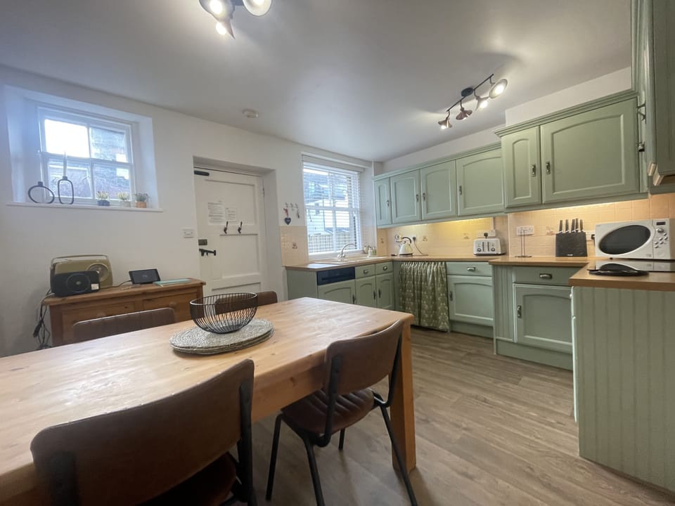The rear entrance leads to the lovely country kitchen and dining space