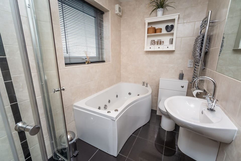 The upstairs bathroom features a bath and walk in shower