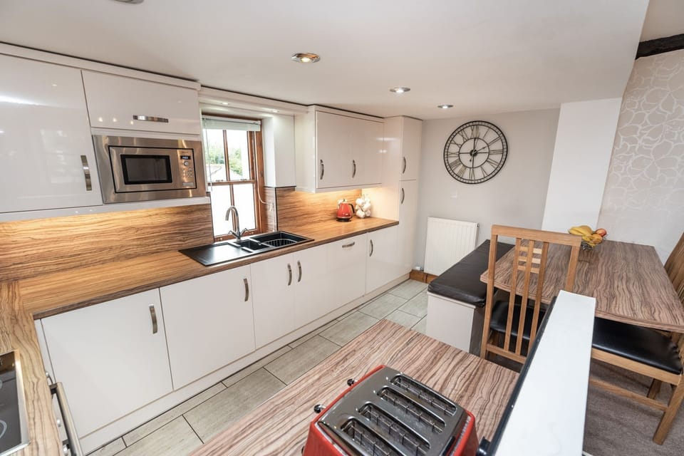 The kitchen enjoys views over the courtyard and garden