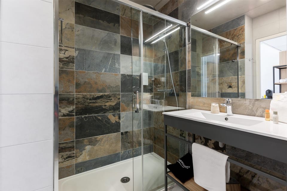 Shower, eco-friendly toiletries, hair dryer, slippers