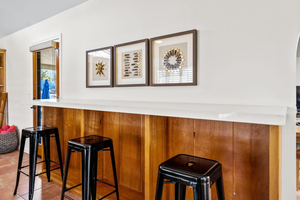 This quartz top bar is perfect for a food buffet with industrial style stools.