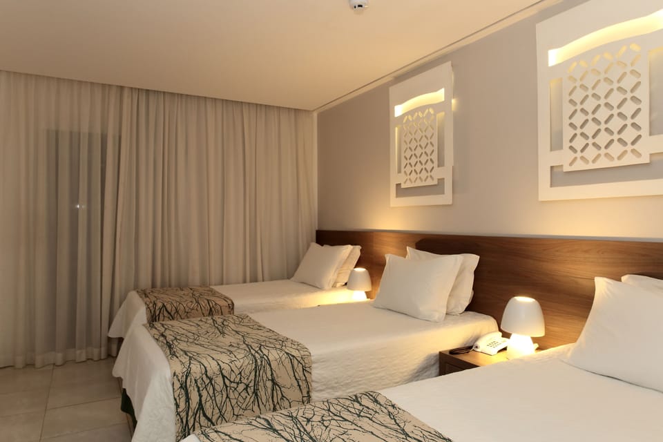 Standard Triple Room | Minibar, in-room safe, individually decorated, blackout drapes