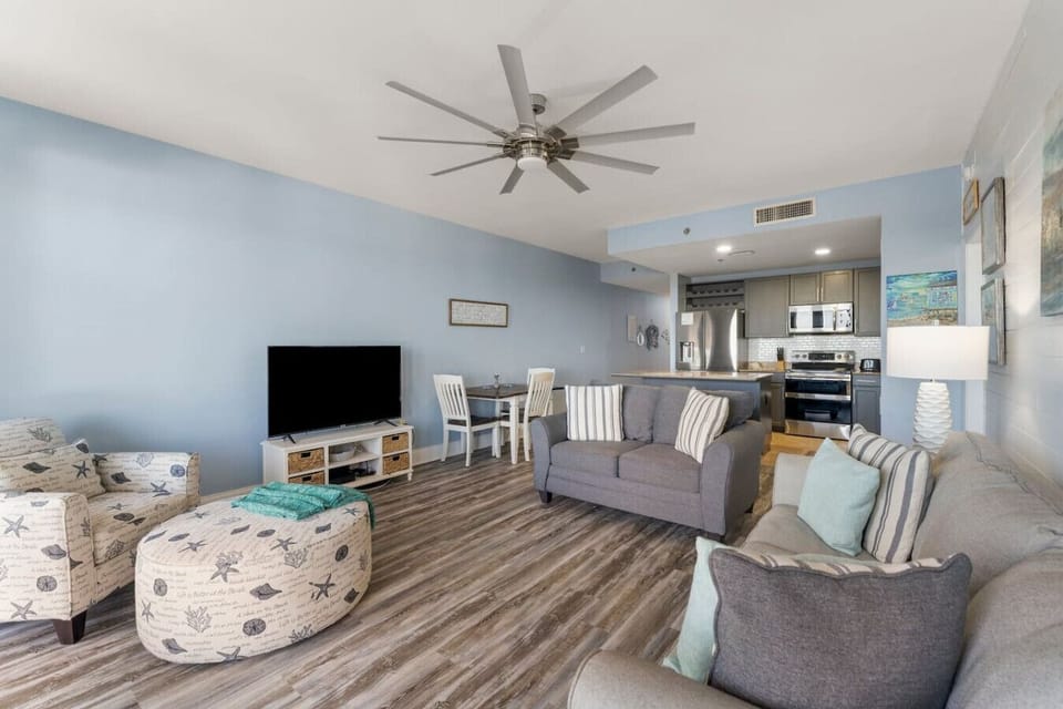 Living Area with Lake and Light Show Views, Flat Screen TV, Sleeper Sofa and Private Balcony Access