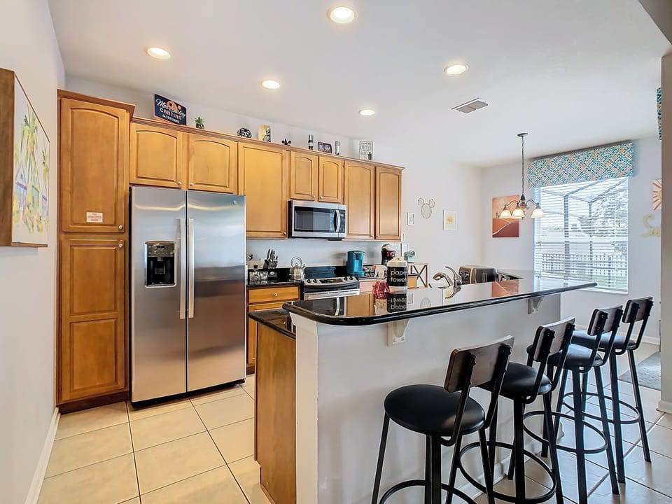 The well-equipped kitchen is just off the living room with counter seating for 4
