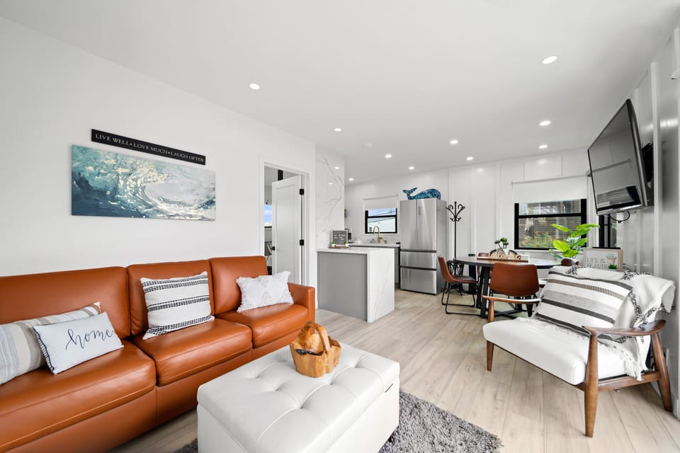 Beautiful modern Living room with leather coach that opens to queen size bed