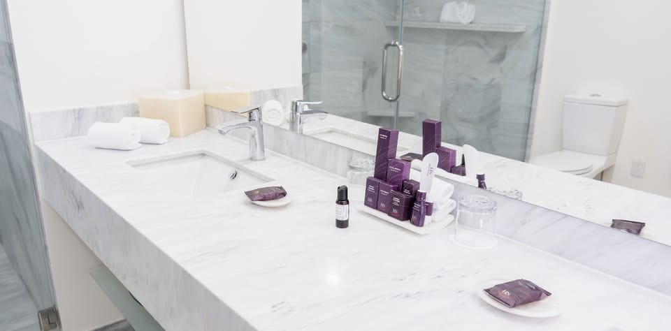 Junior Loft Room | Bathroom | Shower, rainfall showerhead, designer toiletries, hair dryer