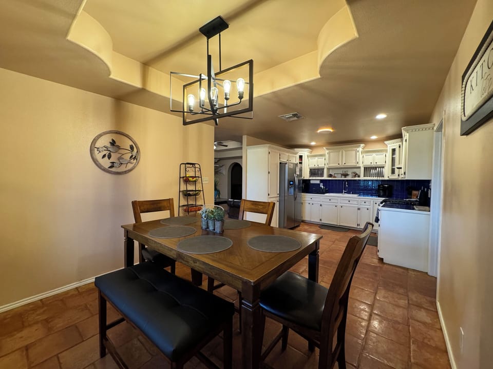 Kitchen are with 3 chairs and a bench