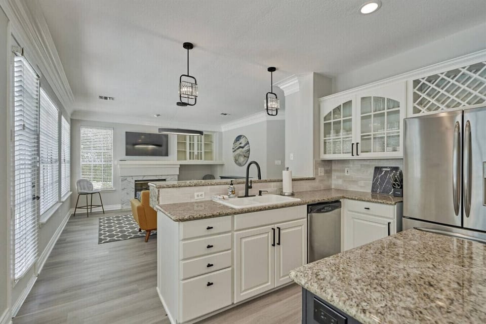 The generous kitchen island and marble counters make this a favorite gathering spot during your stay.