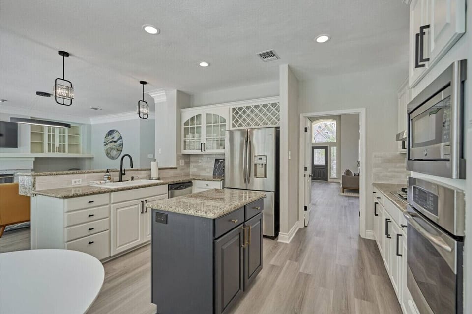 The fully equipped kitchen with its large island makes it easy for the whole group to help out with meals or grab a quick snack.