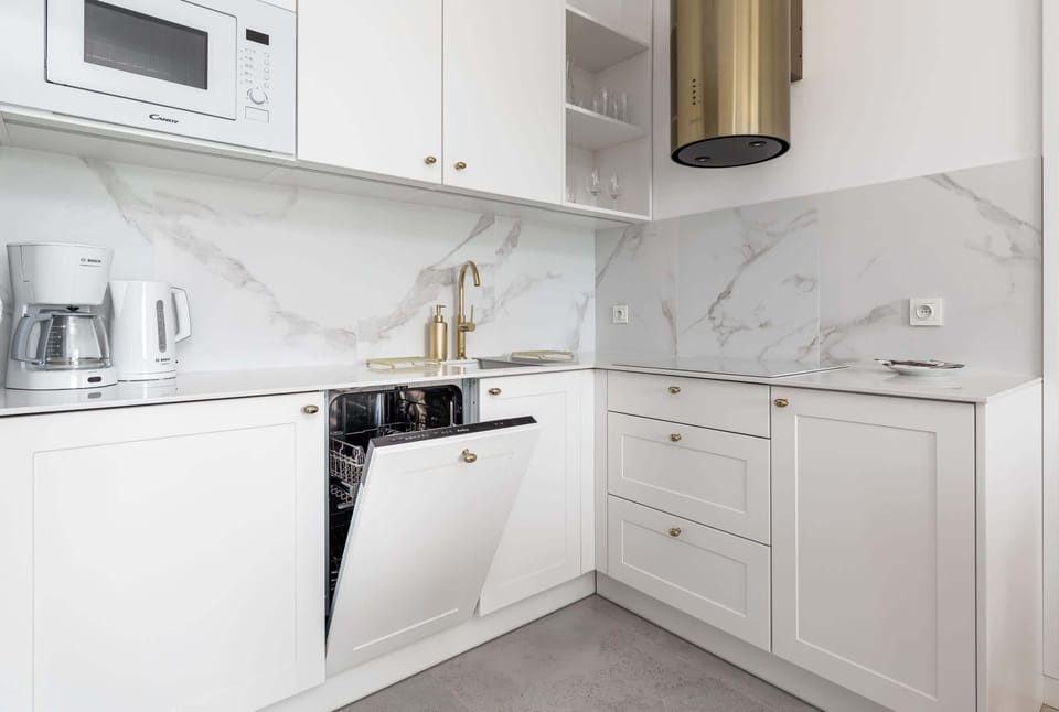 Kitchen corner view with modern appliances, bright lighting, and clean finishes.
