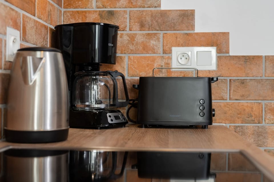 Modern kitchen close-up with small appliances and wooden countertop details.
