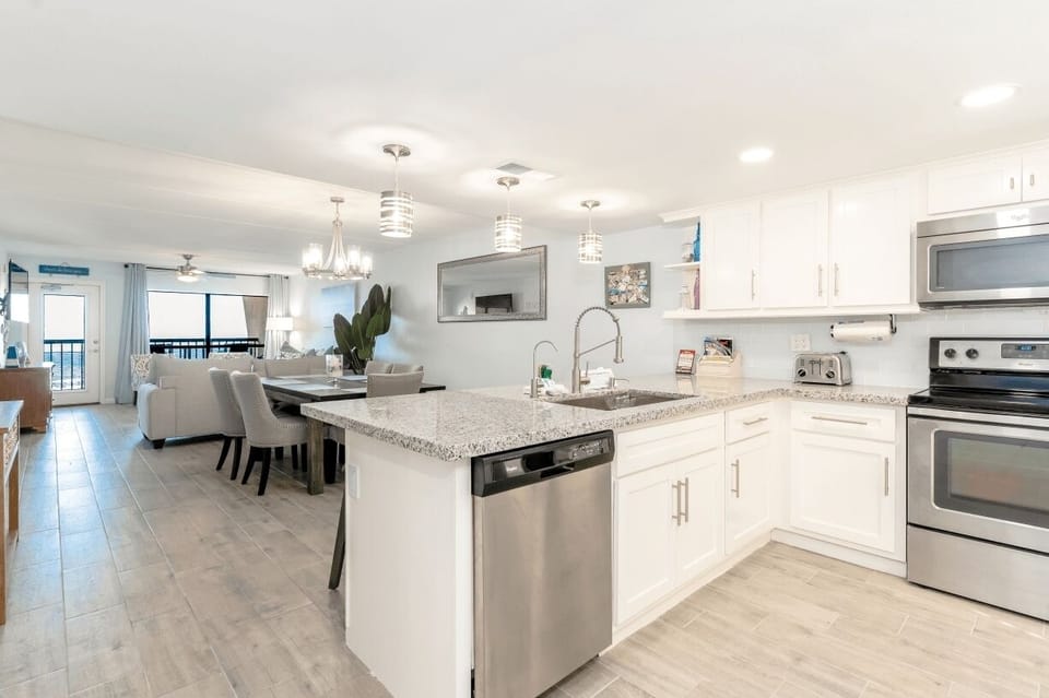 Our bright kitchen overlooks the breakfast bar and dining room.