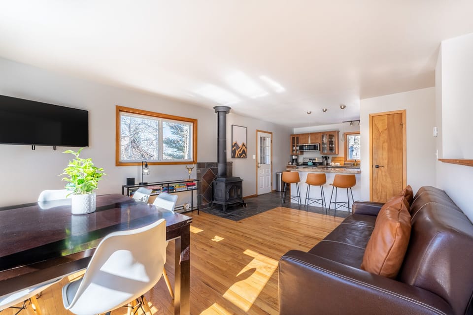 Main level living area offering a mounted Smart TV, surrounding windows, and new furnishings.