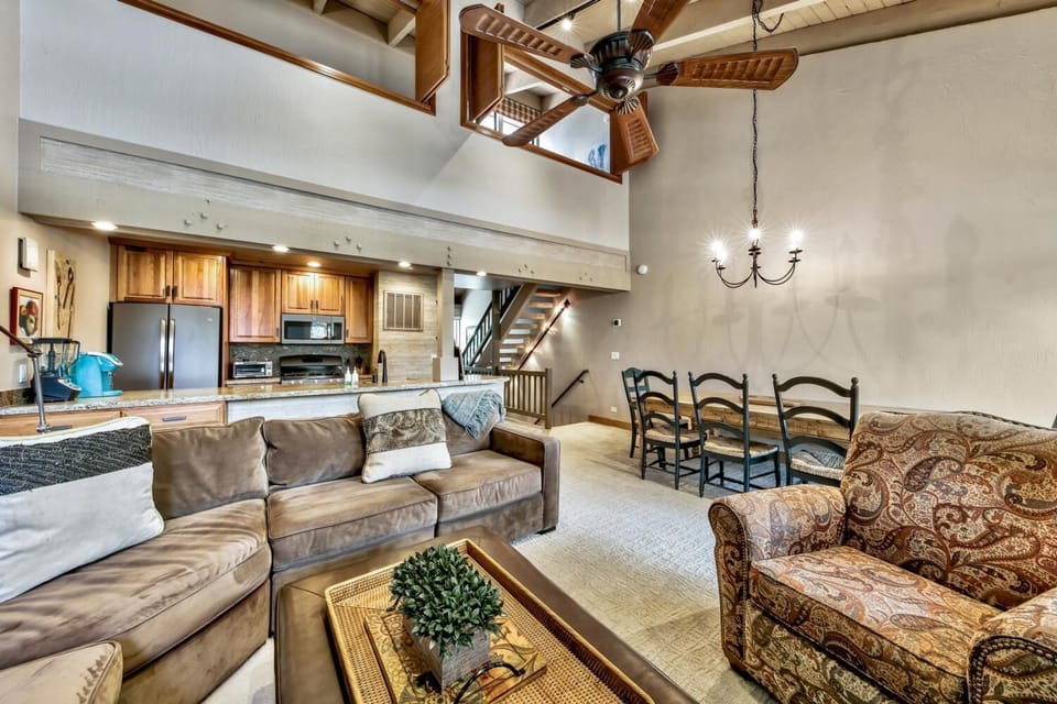 Relax in your spacious open-concept living area with soaring ceilings, cozy seating, and a full kitchen perfect for memorable gatherings.