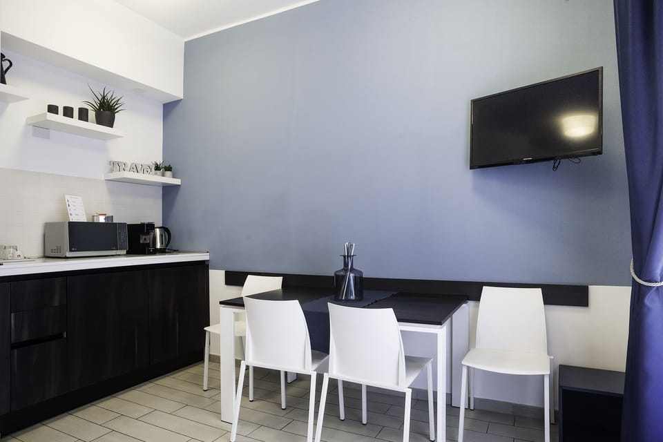 Comfort Quadruple Room, Balcony | Living area | Flat-screen TV