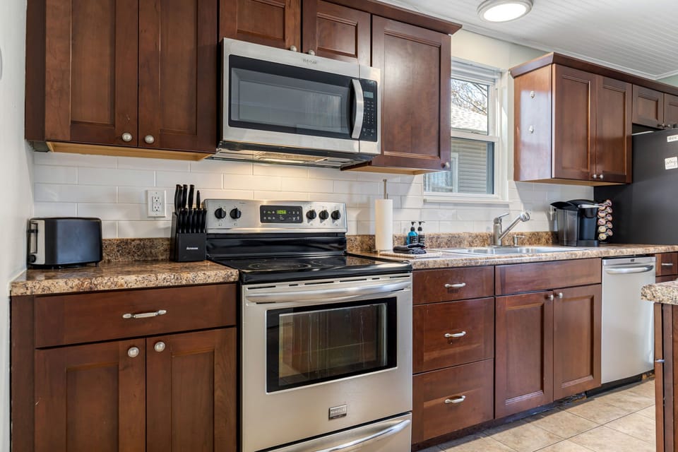 The kitchen includes a stainless range and microwave surrounded by ample cabinetry and counter space.