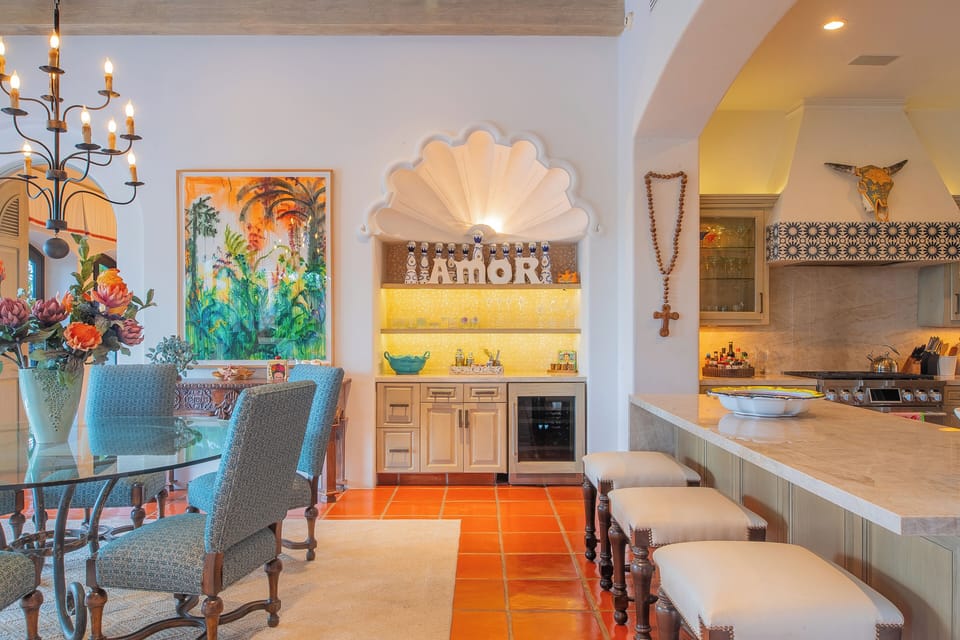 Step into a vibrant open space where dining meets your fully equipped kitchen, all bathed in warm light and rich color. Spanish-tile floors and custom details create a welcoming heart for your stay.