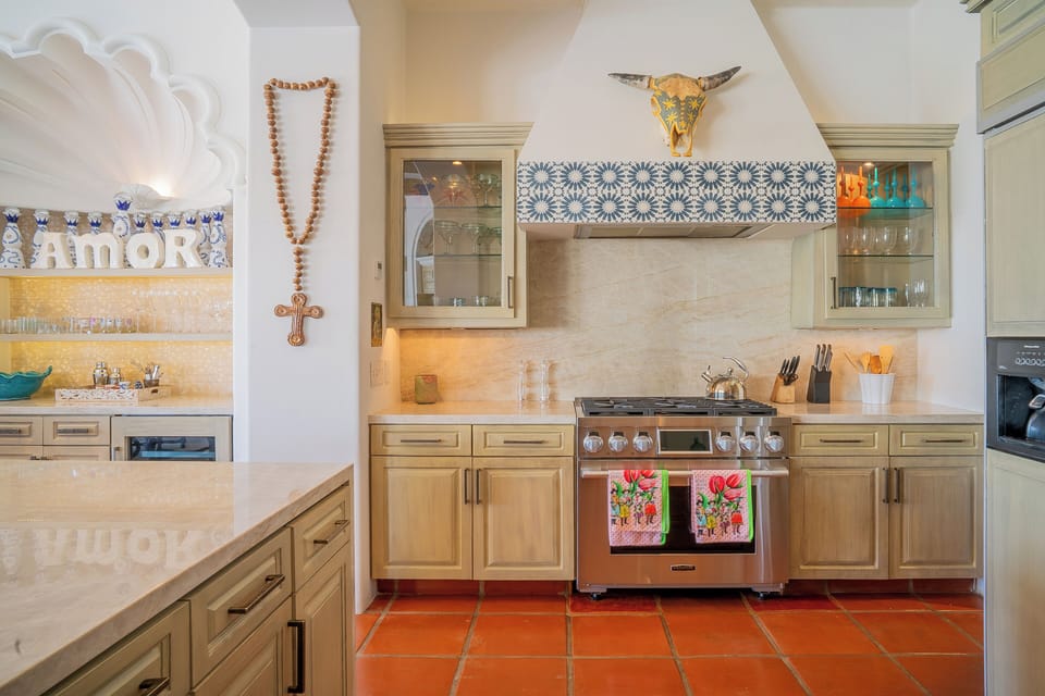 Your own fully equipped kitchen with stainless steel appliances, custom cabinetry, and charming terracotta tile flooring perfect for preparing meals in style during your stay.