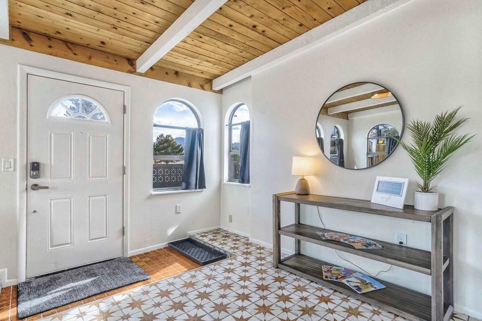 Bright and inviting entryway with rustic wood beams and tile flooring.