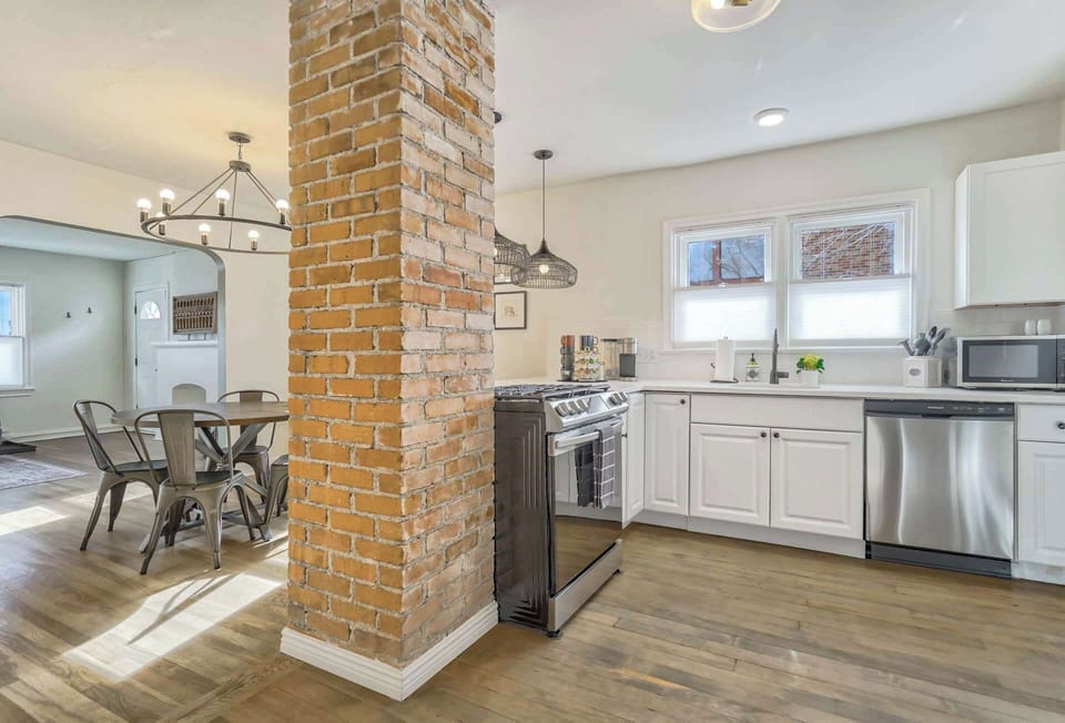 Cook your favorite meals in this well-equipped kitchen with modern appliances and a charming brick accent.
