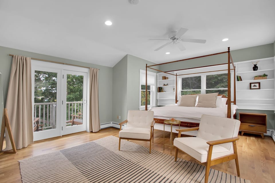 Master bedroom with king size bed and balcony overlooking yard