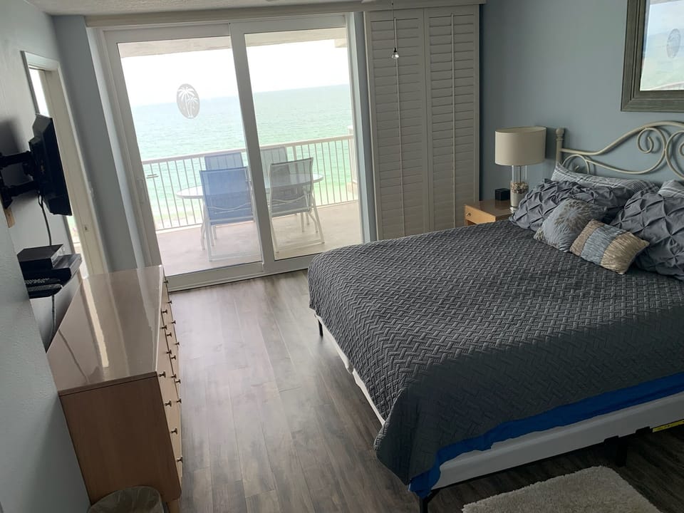 Master bedroom with NEW hardwood flooring & a great view of the ocean.
