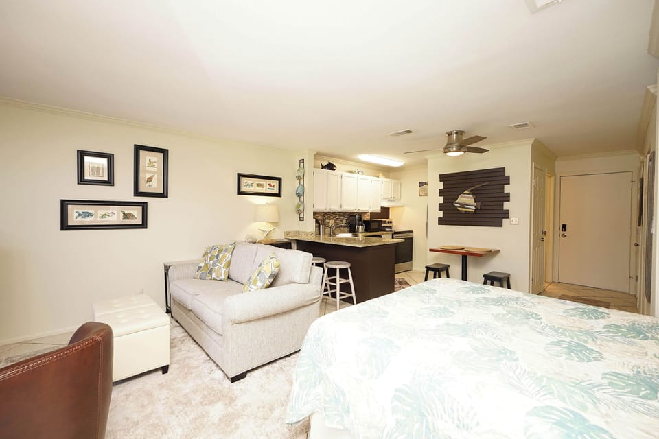 Your comfortable studio combines restful sleep with coastal charm, featuring a cozy living area and fully equipped kitchen for memorable stays.