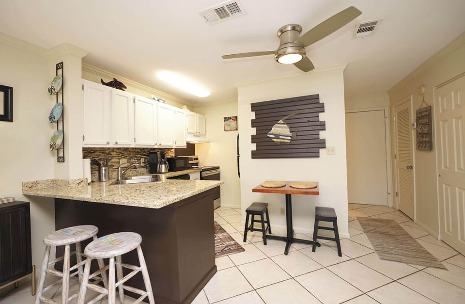 Your fully-equipped kitchen features granite counters, modern appliances, and a cozy breakfast bar where you can start each morning with coffee.