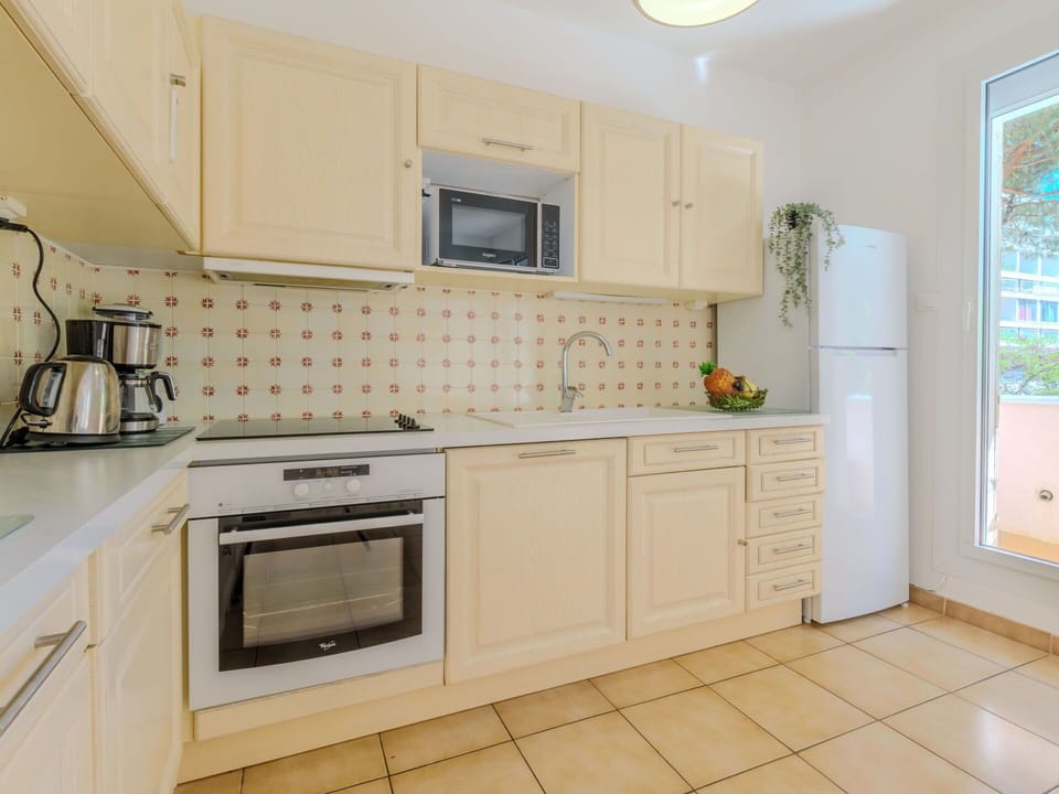 Cabinetry, Property, Countertop, Kitchen Stove, Sink, Kitchen Appliance, Kitchen, Lighting, Interior Design, Wood